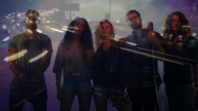 Posing five bandmates in casual gear holding mic skateboard sticks on purple stage with city lights