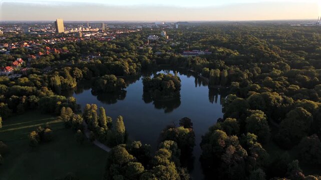 Aerial view of Kleinhesseloher See in the English Garden, Munich, Germany. Famous Bavarian park with lake, islands, nature and culture. Popular summer destination in central Europe