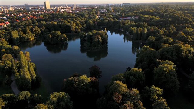 Top view of the English Garden with Kleinhesseloher See, Seehaus Munich, Schwabing and Isar. Scenic landscape of Bavaria, Germany. Wide panorama of the largest park in Munich