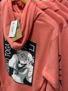 Coral hoodie featuring Himiko Toga anime character graphic print and Japanese text - Dusseldorf, Germany. January 23 2026 - Dusseldorf, Germany. January 23 2026.