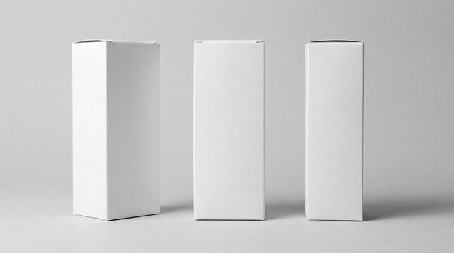 Three plain white rectangular product packaging boxes standing upright on a light background.
