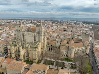 Naklejka premium Aerial view of Narbonne France Cathédrale Saint-Just et Saint-Pasteur and Palais-Musée des Archevêques dramatic sunset view
