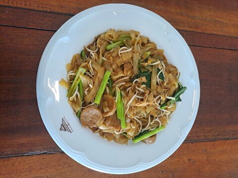 Indonesian Bakso Meatball Noodle Soup in White Bowl on Wooden Table