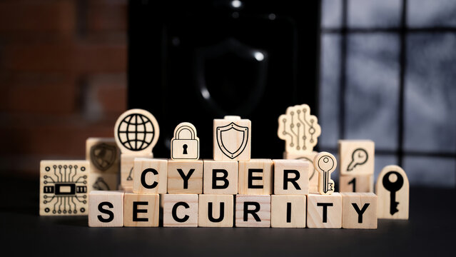 Wooden blocks spell 'Cyber Security' surrounded by related icons like a padlock, shield, and keys.