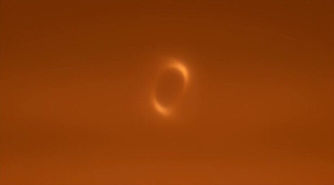 Simulated depiction of a black hole accretion disk with a distorted appearance