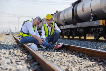Railway Worker Suffering Leg Cramp During Track Inspection