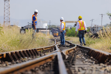 Railway Engineers Inspecting Track Switch Mechanism at Rail Yard