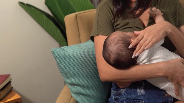 Nurturing Young Mother  breastfeeding newborn infant in chair
