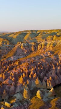 Vertical video. Goreme, Nevsehir, Turkey. Fragile ecosystem of Devrent Valley with unique geological formations needing preservation during evening hours.. Aerial View, MasterShots, Circle (Far). Ric