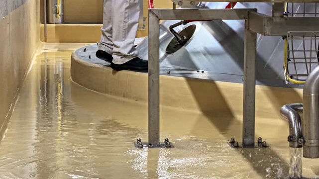 Industrial pipes system with liquid on factory floor processing plant water flow