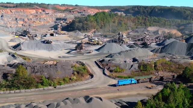 Wide aerial drone backdrop of quarry mining aggregate processing operation with conveyor systems and gravel piles