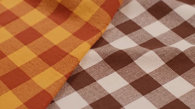 Close-Up of Two Gingham Pattern Fabric Pieces in Warm Tones, Gentle Movement