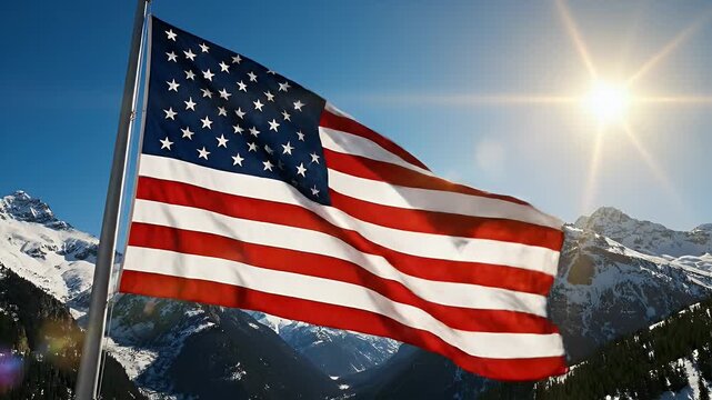 American Flag Waving in the Mountains - The National flag of the USA waves proudly on a pole, set against a majestic mountain backdrop. A clear blue sky and the sun provide a stunning background.