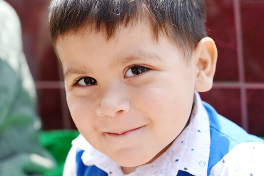 Latin little boy smiling happily.
