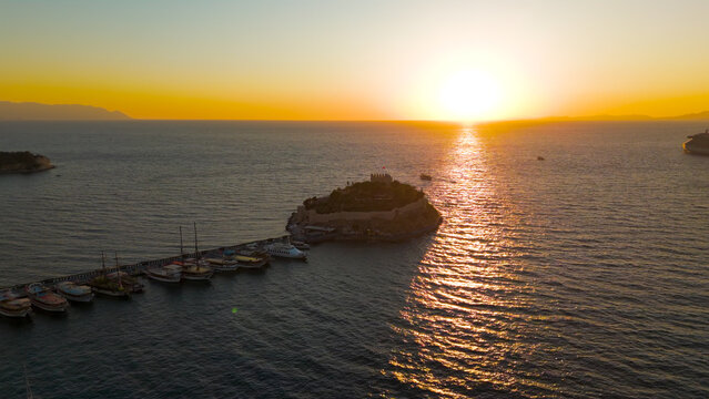 Kusadasi, Turkey. Historic Pigeon Island Fortress, once the base of Admiral Barbarossa, at sunset. Captures the iconic Pirate Castle. Aerial View