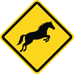 A yellow isolated traffic sign with a black horse silhouette serves as a caution for a wildlife road crossing to warn of potential highway danger and animal hazards