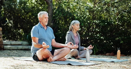 Fotobehang Lotusbloem Yoga, fitness and old couple in garden, meditation and exercise for health benefits, zen and chakra. Nature, senior man and woman in backyard, relationship and lotus pose for breathing and retirement  © peopleimages.com