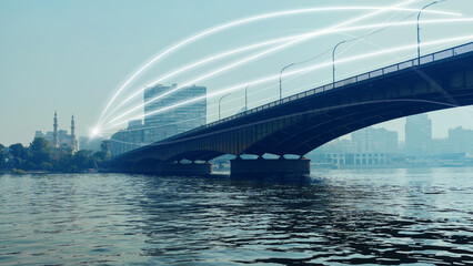 Fototapeta premium View of a bridge over water with light lines during daytime in a city