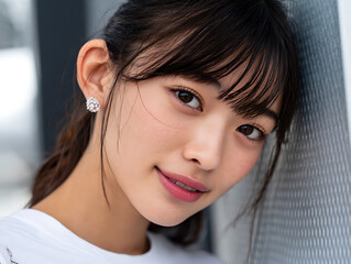 Young Woman Poses Near a Metal Structure in an Urban Setting During Daylight Hours
