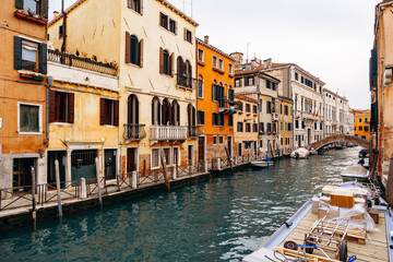 Canal view with buildings and boats in Venice during a cloudy day © fotofabrika