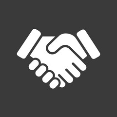Obraz premium Two white hands shaking on a dark background showing agreement and collaboration