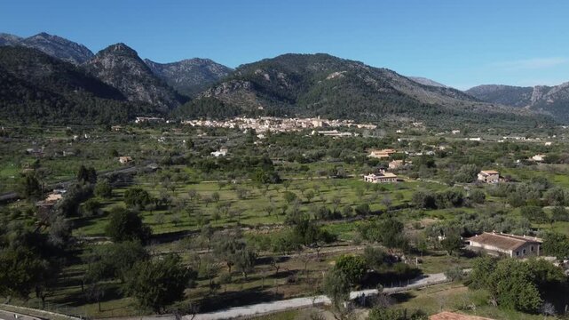 Aerial view from a road towards the village of Caimari at the base of the Serra de Tramuntana mountain range, Mallorca, Spain