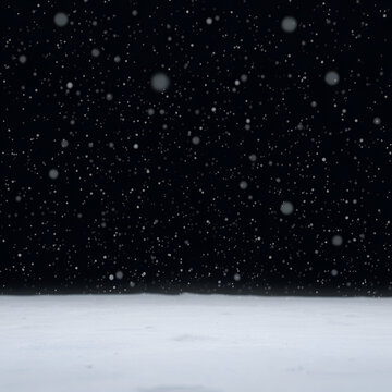 Snowflakes settle on the ground in a vast expanse of black, peaceful, cold