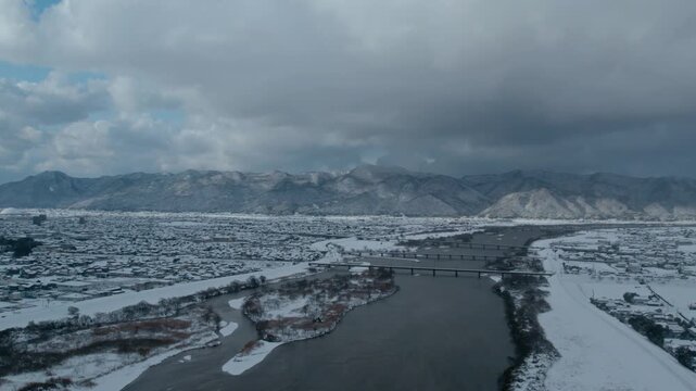 Aerial Drone View of Hii River in Izumo Japan Covered with Snow &ndash; Winter Landscape