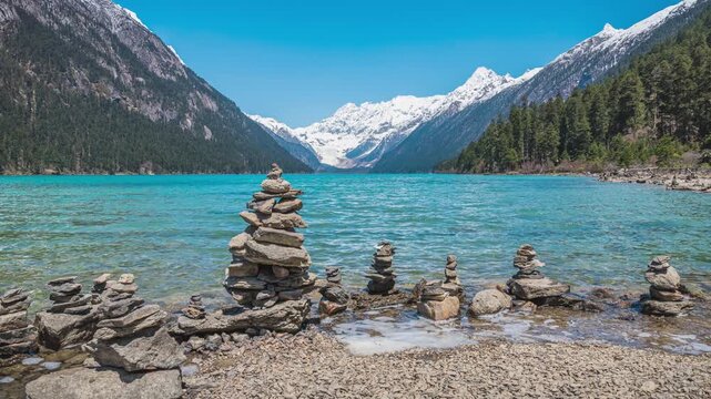 Time-lapse of Mani Stones, Lake, Forest and Snow Mountains at Xin Co in Nyingchi, Tibet, China