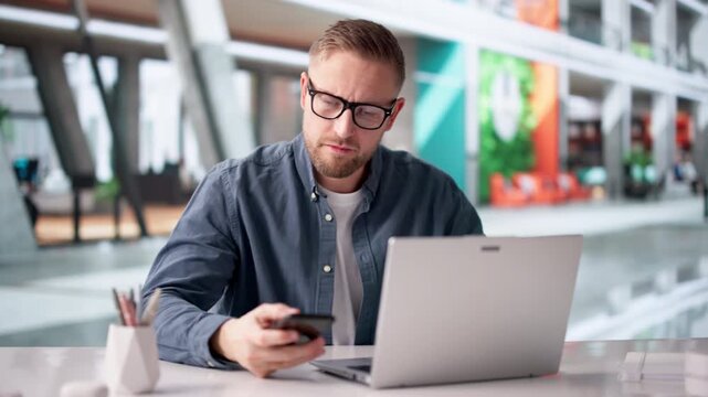 Man Carefully Checks Smartphone For Payment Issues