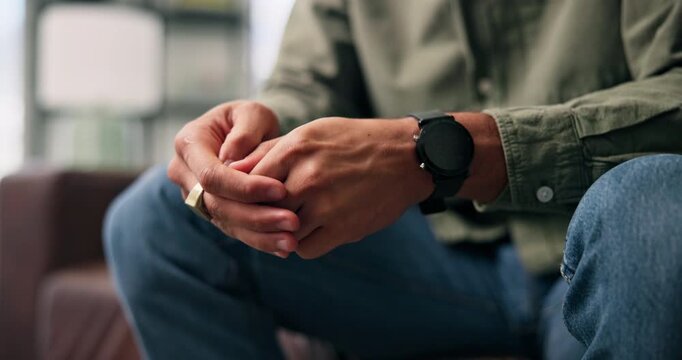 Anxiety, hands and man in home with stress, overthinking or mistake with wrong decision in lounge. Sofa, coping mechanism and nervous person with worry, trauma or stimming for mental health crisis