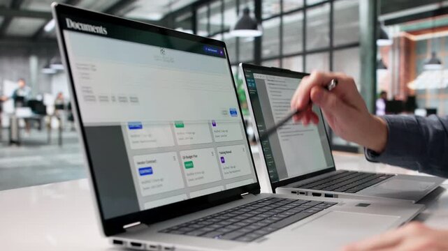 Archivist Carefully Organizes Digital Files On Notebook