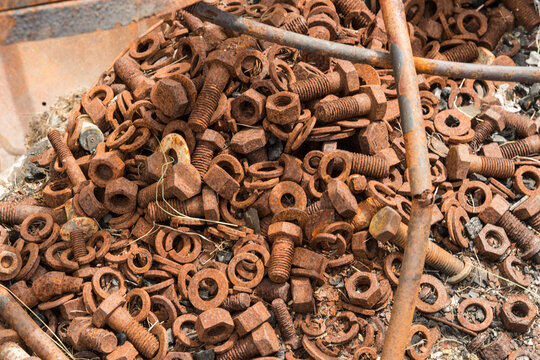 Canada, BC, Ashcroft.  A pile of rust covered nuts and bolts and other debris in the remains of a auto repair shop after fire