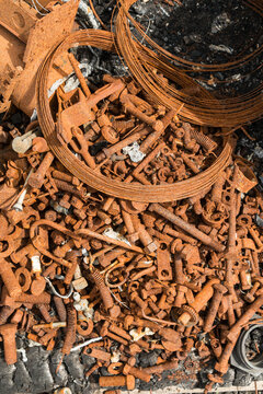 Canada, BC, Ashcroft.  A pile of rust covered nuts and bolts and other debris in the remains of a auto repair shop after fire