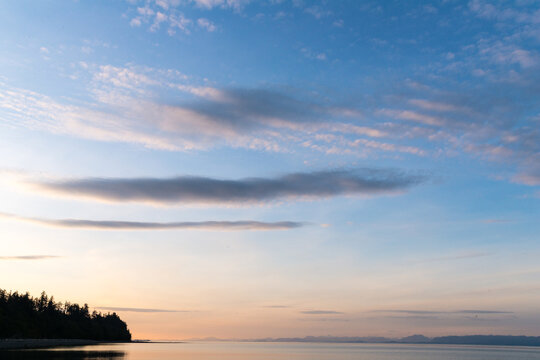 Canada, BC, Denman Island.  Benign clouds over the Strait of Georgia at sunset.