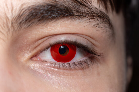 A striking red eye with intense gaze captivating detail and dramatic effect for halloween concept