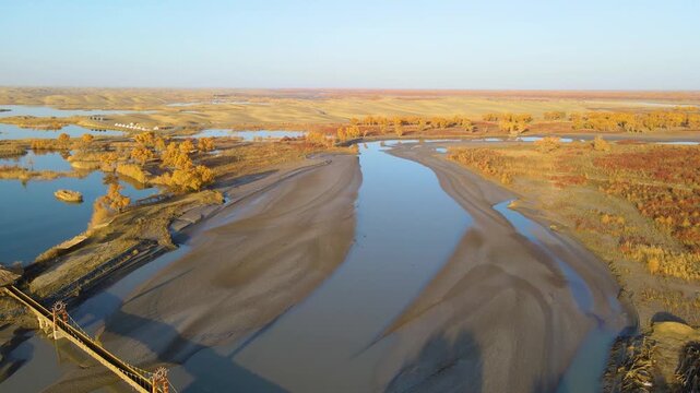 Aerial Time-lapse of Golden Populus Euphratica Forest and Tarim River at Lop Nur Village in Yuli, Xinjiang, China