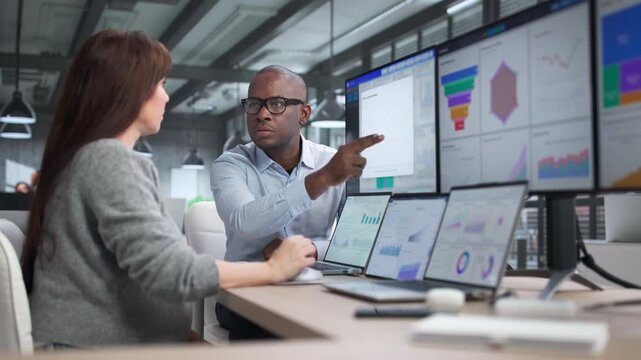 African American Business Analyst Reviewing Financial Data Analytics Dashboard