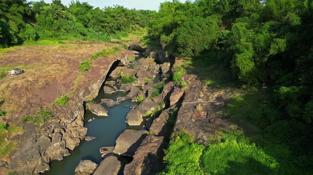 Slow pan perspective of Bucal Tulay river water flowing over textured rock formations in natural daylight at Maragondon Cavite Philippines