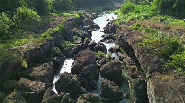 Top down aerial view showing Bucal Tulay river water moving over huge rock formations and natural riverbed at Maragondon Cavite Philippines