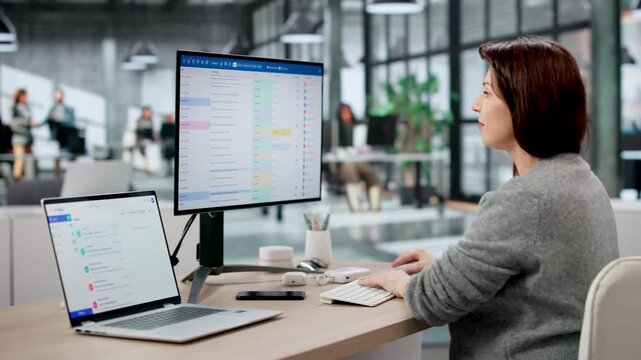 Two Young Professionals, A Woman And A Man, Using Project Management