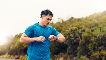 Runner, smart watch and check with man in nature for fitness tracker, performance app and health...