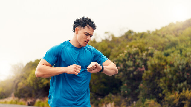 Runner, smart watch and check with man in nature for fitness tracker, performance app and health stats. Running progress, online training schedule and wellness with person outdoor for stopwatch timer