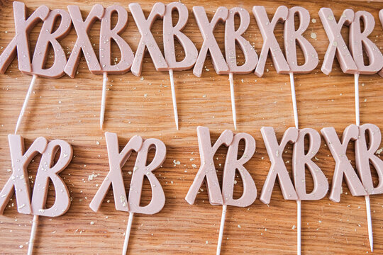 Moscow, Russia, 18.04.25. Easter cookies with Russian abbreviation XB letters on sticks placed on wooden board. Traditional Christian religious holiday dessert. Home kitchen food preparation. Easter b