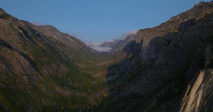 Wide canyon landscape with towering granite faces in Bitterroot National Forest Montana