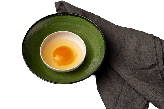 raw egg in a smalltalk bowl on the table