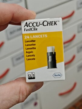 Prague,Czech Republic-April 2 2026: Accu Chek lancets for glucose meter stored on pharmacy shelf