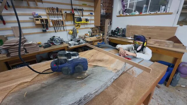 Professional Maker Conducting Quality Assurance Audit on Timber Slab with Straightedge in Modern Workshop