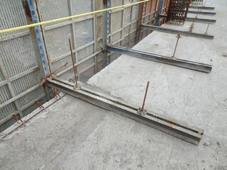 Daytime View of Concrete Floor with Metal Framing and Yellow Caution Tape at an Industrial Construction Site &ndash; Photo Perspective
