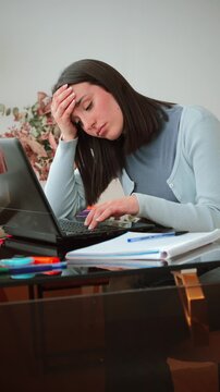 A frustrated woman shows visible signs of stress while working on her laptop. She appears overwhelmed by the tasks ahead, illustrating the challenges of remote work and the pressure to perform
